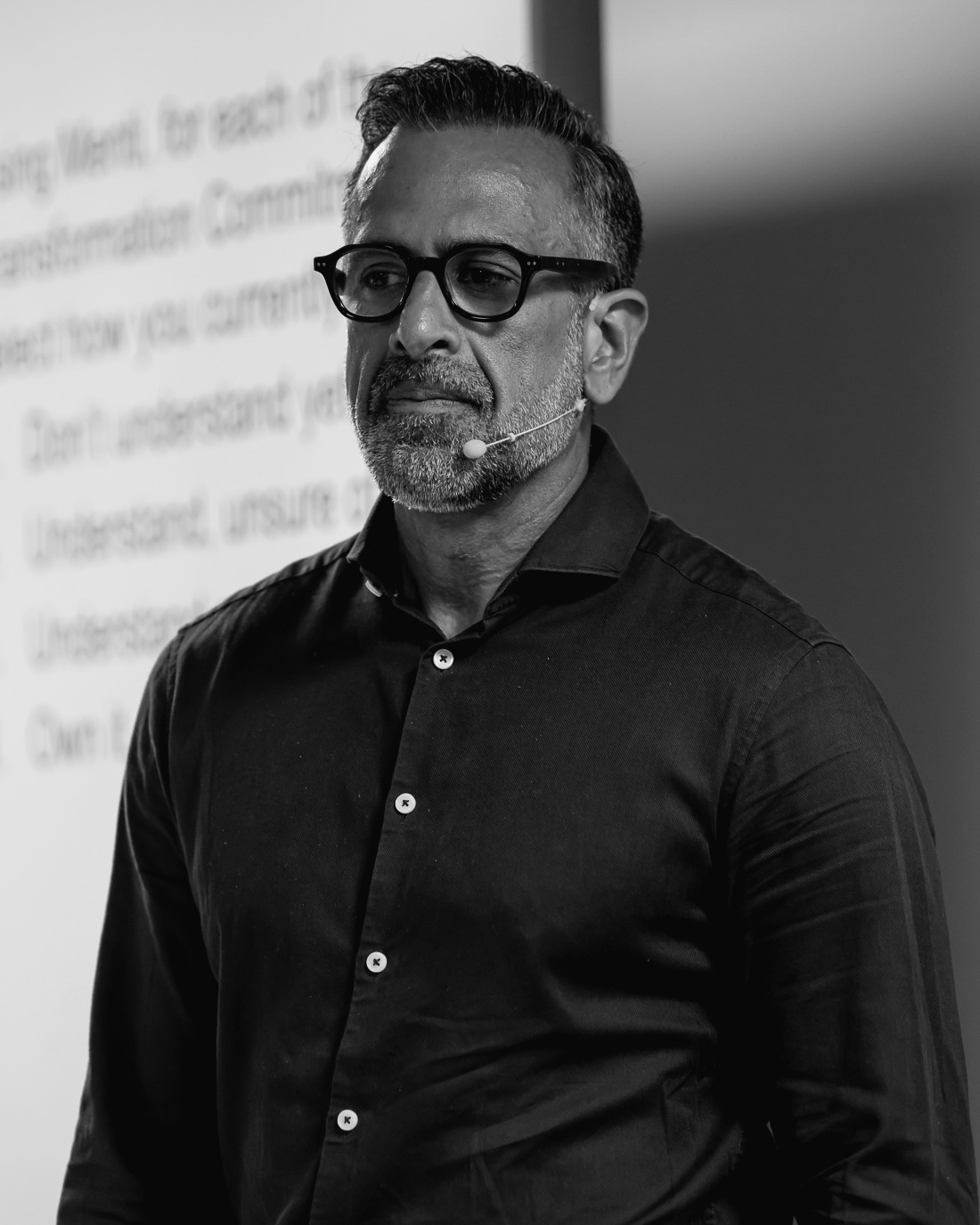 Faried Chopdat speaking at an event, black and white portrait